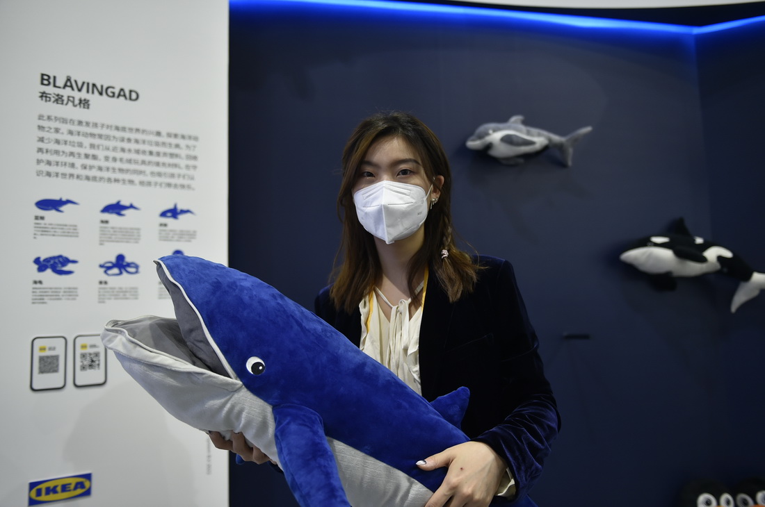 11月7日，在第五届进博会消费品展区，工作人员展示一款毛绒玩具。据介绍，该系列毛绒玩具的填充材料由近海水域收集的废旧塑料经过回收再利用而制成。新华社记者 鲁鹏 摄